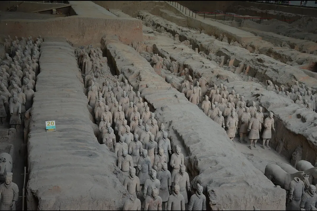 Rows of terracotta warriors standing in the earth corridors of Pit 1, seen from above